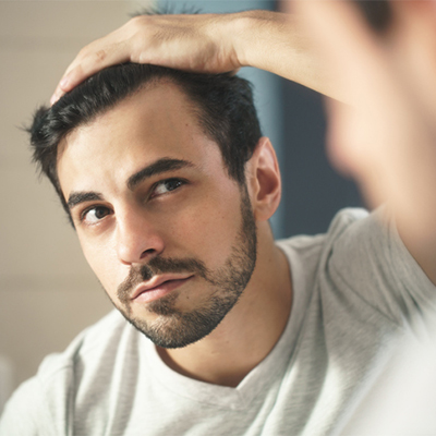 Mature man looking himself in the mirror