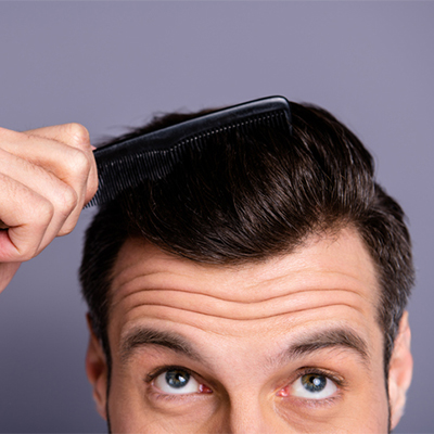 Man brushing his hair with a comb