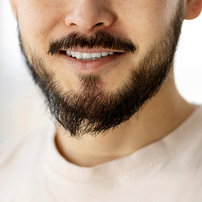 Closeup portrait of handsome smiling bearded man