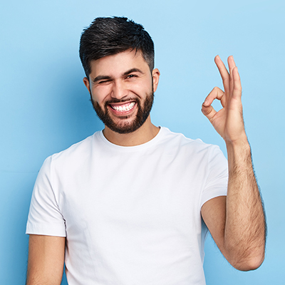 Happy funny bearded man winking his eye and showing ok sign